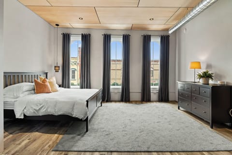 Bedroom area with King bed and large windows overlooking Main Street below
