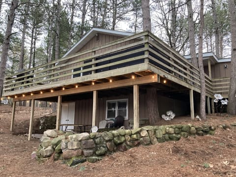 Upper area seating, table & chairs up with a grill, picnic table below 