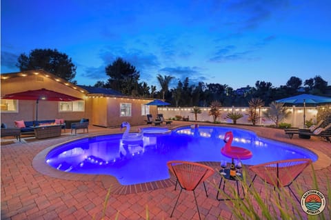 Twilight turns the backyard into a glowing oasis with floaties loungers and pool