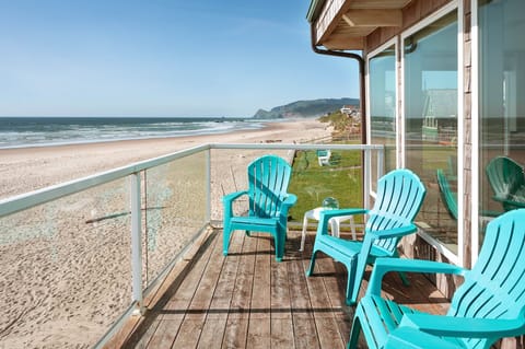 Oceanview deck w/ colorful chairs perfect for relaxing by the shore.