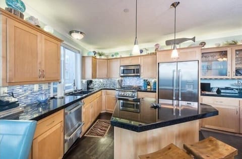 Open kitchen w/ warm wood cabinets & plenty of prep space