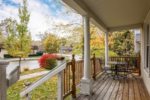 Relax on the covered front porch w/ rocking chairs & leafy neighborhood views