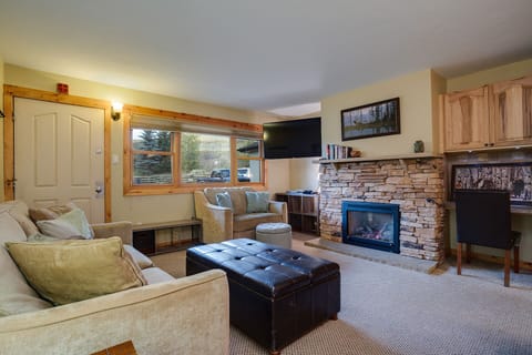 Cozy up in your mountain retreat's living room where plush sofas and a crackling stone fireplace create the perfect atmosphere for relaxation.