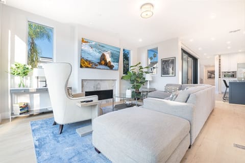 The open floor plan allows the living room to easily transition to both the kitchen and hallway beyond
                