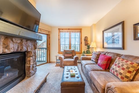Cozy up in your mountain retreat with plush leather seating, crackling fireplace, and stunning views through expansive windows.