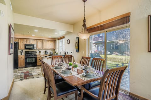 Gather around your elegant dining table for memorable meals, with a fully equipped kitchen just steps away for convenient meal preparation.