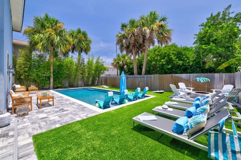 Resort-style pool deck with plenty of seating and umbrellas