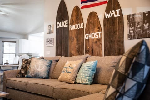 Stylish living room with surfboard décor and comfortable seating.