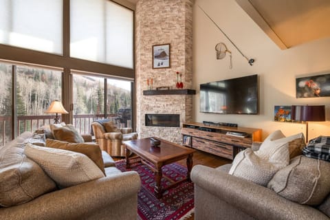 Cozy up by the towering fireplace with stunning forest views!