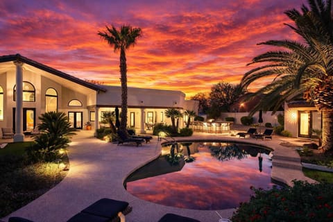 Resort style backyard with private pool, hot tub, lounge chairs, outdoor dining, corn hole, built in grill and fire pit!