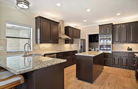 Fully stocked kitchen with bar and island.  A second fridge is located in the garage space.