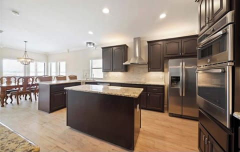 Fully stocked kitchen with bar and island.  A second fridge is located in the garage space.