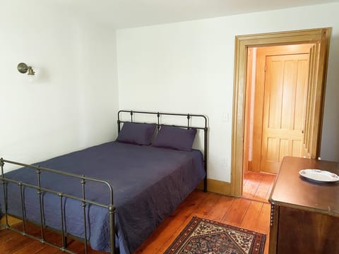 East bedroom with vintage queen bed