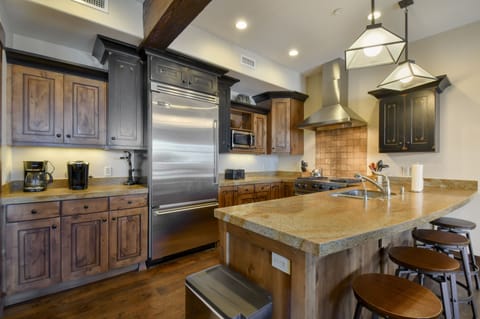Large kitchen, fully stocked with high-end appliances.