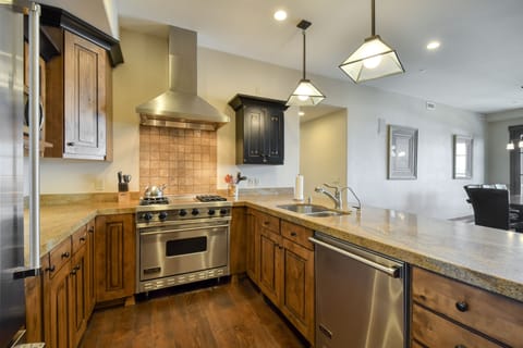 Gas stove with center griddle and overhead fan. Large oven. Dishwasher and sink with garbage disposal.