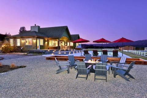 Spacious outdoor lounge with fire pit and sunset views