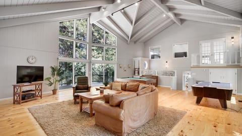 Living room with pool table, foosball table, Roku TV, large coffee table for board games