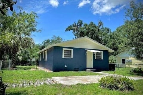 Back of house with car port
