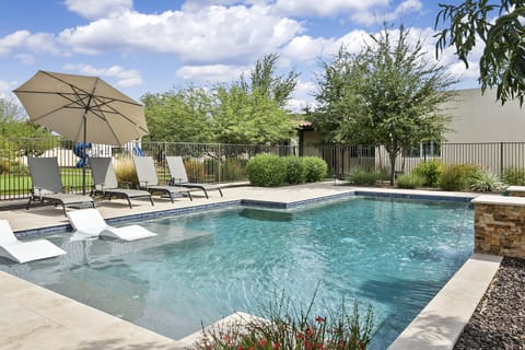 Private gated pool with plenty of seating and hot tub