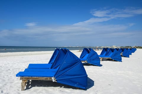 In peak season, concessionaires rent lounge chairs to guests on the Island Winds beachfront.