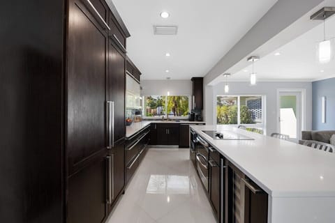 Prepare a family meal in the fully-equipped kitchen offering bar seating, updated appliances and pool views.