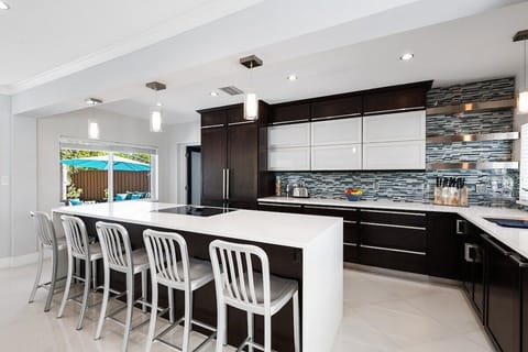 Prepare a family meal in the fully-equipped kitchen offering bar seating, updated appliances and pool views.