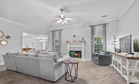 Living room with sectional, swivel chair and gas fireplace!