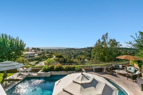 View from master bedroom balcony of pool below and sunset views