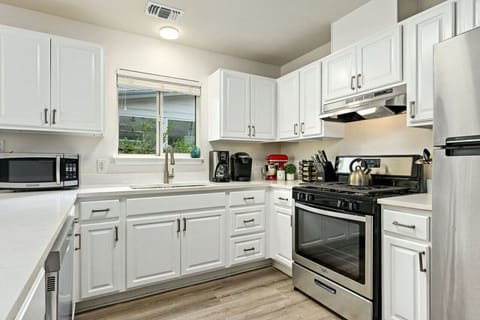 Bright, modern kitchen with stainless steel appliances and coffee bar—perfect for fueling up before a day in downtown Austin.