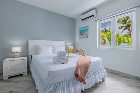 Wake up to swaying palm trees! This serene, modern bedroom offers the perfect peaceful oasis to recharge after a day in the sun. Crisp linens, cool AC, and island views await.