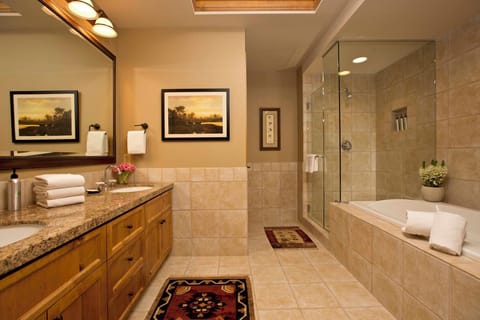 Dual sinks and a separate soaking tub outfit the primary bathroom.