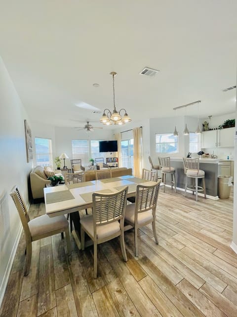 Gather around your stylish dining table where natural light fills the open-plan space, connecting seamlessly to your modern kitchen.