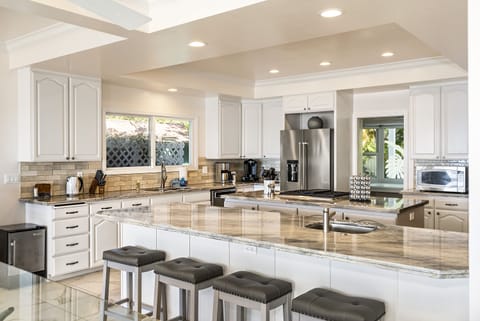 Gather around the stylish breakfast bar — perfect for casual dining or morning coffee chats.