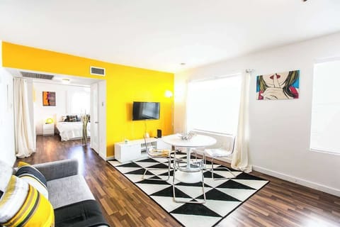 Relax in this airy bedroom with comfy seating, modern decor, and city views—ideal for groups or long stays.