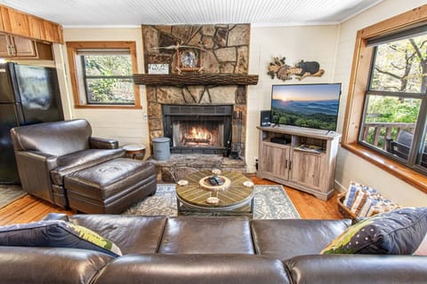 Cozy living room with wood burning fireplace, TV, high speed Wi-Fi, and cable