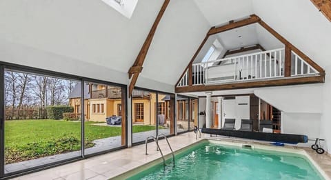 Bright indoor pool with garden views, perfect for relaxing.