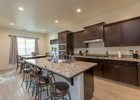 Modern kitchen with full amenities and large island for cooking or gathering.