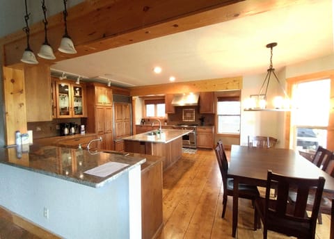 Custom kitchen features high end appliances, an island and a breakfast table