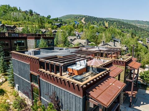 Private rooftop deck with a fire pit, outdoor seating, hot tub and gorgeous views