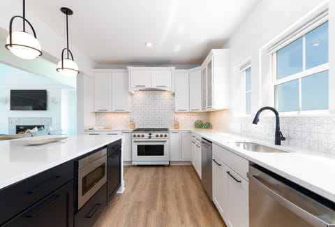 Gourmet kitchen with stainless steel appliances, two refrigerators, and two dishwashers for large groups.