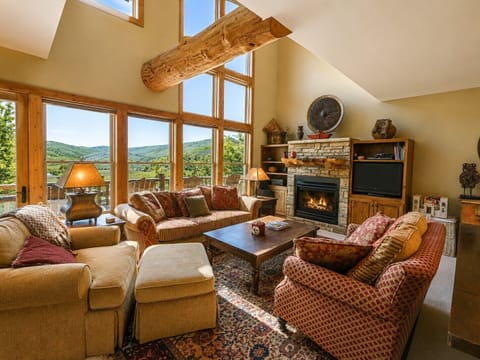 Spacious, sun-filled living room with mountain views and gas fireplace