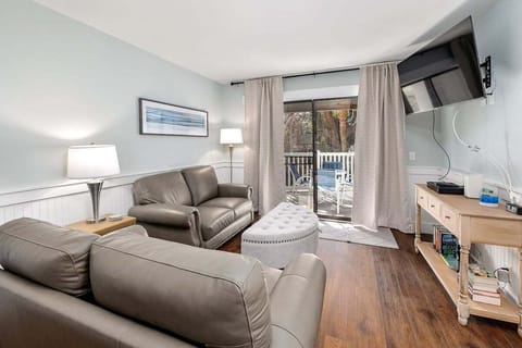 Shipwatch 102 - Living Room area with 2 couches, TV and balcony access