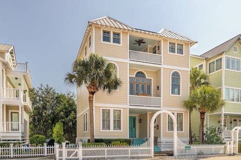 Front exterior of 20 Coast - Tag Knot Cottage with surrounding picket fence
