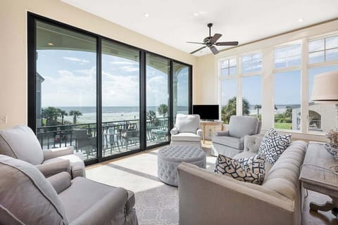 Living room with floor-to-ceiling windows and ocean view