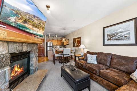 Cozy up by your crackling fireplace with mountain views on the big screen, plush leather seating, and a fully equipped kitchen nearby.