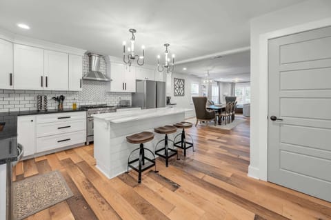 Modern kitchen featuring a sleek gas range and fully stocked essentials for all your cooking needs. Perfect for preparing delicious meals and enjoying a seamless, home-style dining experience with family and friends.