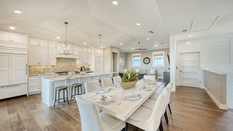 Gather, graze, and toast to good times—this open kitchen and dining area brings everyone together with style and space to spare.