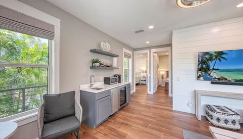 Pour, chill, and cheers—this stylish wet bar with wine fridge keeps the good times flowing just steps from the action.