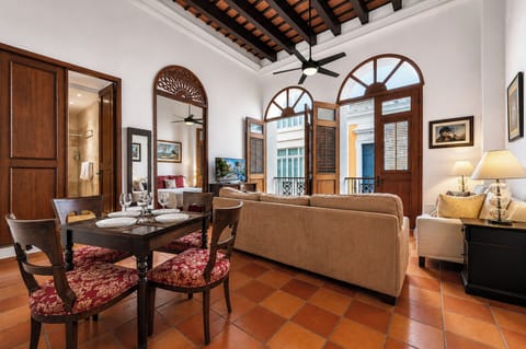 Grand Spanish Colonial living and dining space with soaring ceilings, balconies.