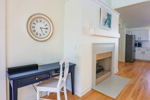 There's a desk near the dining room and living room areas.